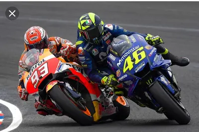 two people riding motorcycles on a race track at Apartamento Mar y Montaña in Argentona