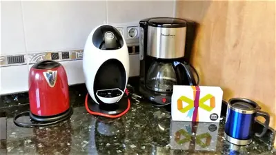 a toaster and coffee maker on a kitchen counter at Helena Seaview & Beach-apartment in Montgat