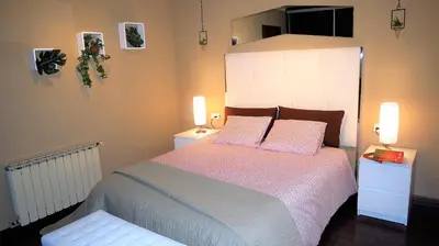 a bedroom with a large bed with pink sheets and pillows at Claire Seaview & Beach-apartment in Montgat
