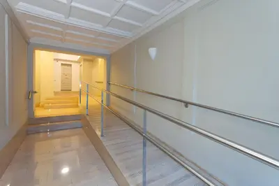 an empty hallway with stairs in a building at Filmoteca Sarria 1- wifi quiet bright comfi in Barcelona