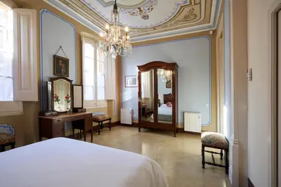 a bedroom with a bed and a desk and a mirror at CAL PADRI1871 - 30min to Barcelona, Groups & Families, Beach Stylish House in Premiá de Mar