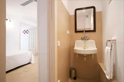 a bathroom with a sink and a mirror at CAL PADRI1871 - 30min to Barcelona, Groups & Families, Beach Stylish House in Premiá de Mar