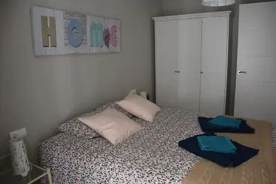 a bedroom with a bed with two towels on it at Apartamento Flavia II Sant Damià in Sitges