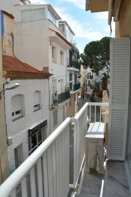 a balcony of a building with a white railing at Apartamento Flavia II Sant Damià in Sitges