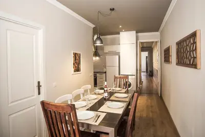 a dining room with a long table and chairs at Mai & Maud Paralel Apartment in Barcelona