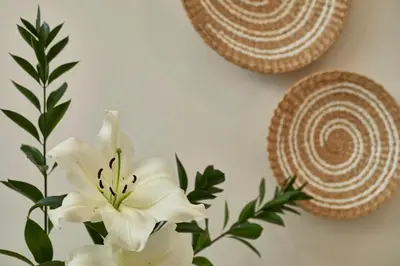 a white flower in a vase on a wall at BBarcelona Gaudí Avenue Flat in Barcelona