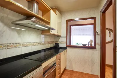 a kitchen with a counter top and a window at BBarcelona Gaudí Avenue Flat in Barcelona