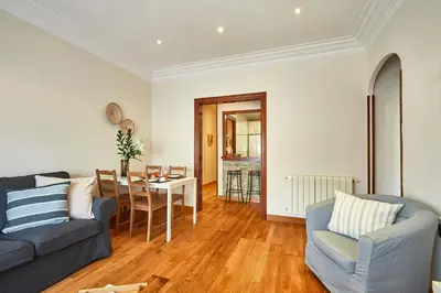 a living room with a couch and a table at BBarcelona Gaudí Avenue Flat in Barcelona