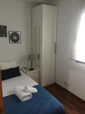 a bedroom with a bed with two towels on it at Apartamento FIRA Barcelona in Hospitalet de Llobregat