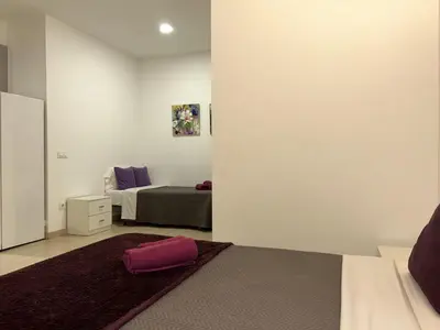 a bedroom with a bed and a mirror at Apartahotel Baldiri in Sant Boi del Llobregat