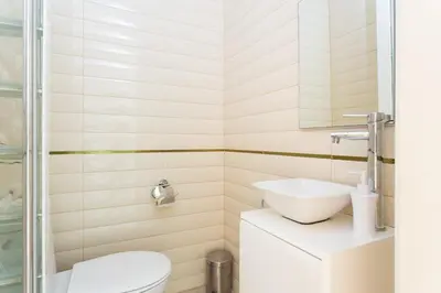 a bathroom with a toilet and a sink at Casa Cosi Letamendi in Barcelona