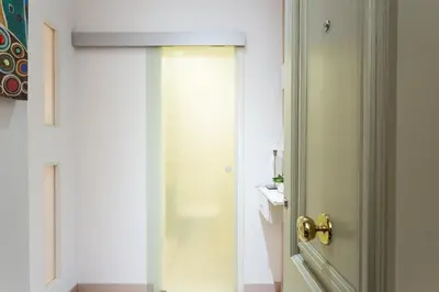a door to a bathroom with a toilet in a room at Casa Cosi Letamendi in Barcelona