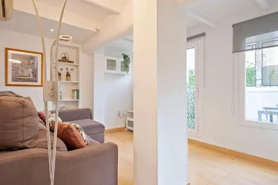 a living room with a couch and a window at Alcam Paseo San Juan in Barcelona