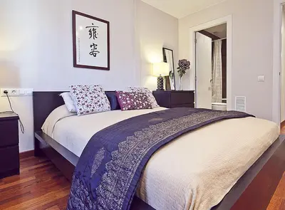 a bedroom with a large bed with purple pillows at Ciutadella Park Born in Barcelona