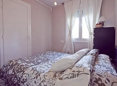 a bed in a bedroom with a window at Ciutadella Park Born in Barcelona