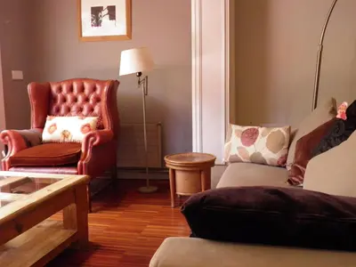 a living room with a couch and a chair at Suitur Courtyard Apartment in Barcelona