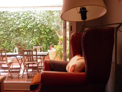 a living room with a chair and a lamp at Suitur Courtyard Apartment in Barcelona