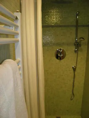 a shower with a glass door in a bathroom at Suitur Courtyard Apartment in Barcelona