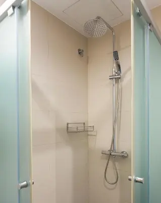 a shower with a shower head in a bathroom at Casa Cosi Sant Antoni in Barcelona