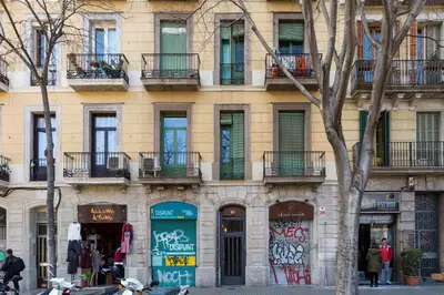 a building with graffiti on the side of it at Casa Cosi Sant Antoni in Barcelona