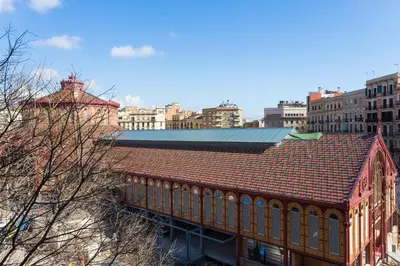 a building with a red roof in a city at Casa Cosi Sant Antoni in Barcelona
