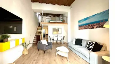 a living room with a couch and a loft bed at Paseo de Gracia Design in Barcelona