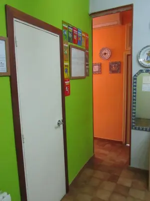 a room with green and orange walls and a door at Pension Alamar in Barcelona