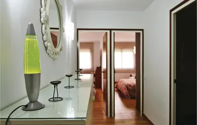 a room with a glass table and a mirror at Gorgeous Apartment In Pineda De Mar in Pineda de Mar