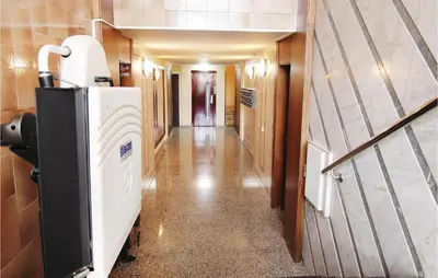 a long hallway with a refrigerator in a building at Gorgeous Apartment In Pineda De Mar in Pineda de Mar