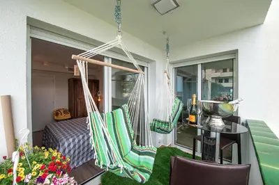 a couple of hammocks hanging from a balcony at La Marina de Aiguadolç in Sitges