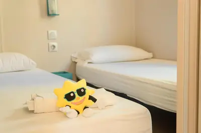 a stuffed toy sitting on a bed in a room at Camping Sènia Caballo de Mar in Pineda de Mar
