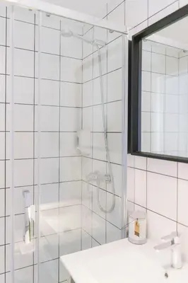 a white bathroom with a shower and a sink at BYPILLOW Wander in Barcelona