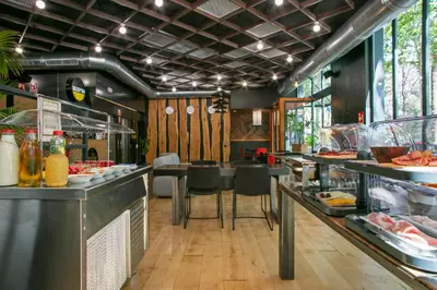 a restaurant with a buffet line with food at Niu Barcelona Hotel in Barcelona