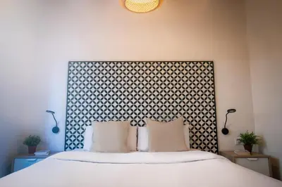 a bedroom with a large bed with white pillows at Modern Catalan Apartments by Olala Homes in Hospitalet de Llobregat