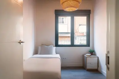 a small room with a bed and a window at Modern Catalan Apartments by Olala Homes in Hospitalet de Llobregat