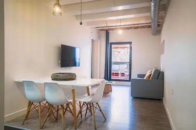 a dining room with a white table and chairs at Modern Catalan Apartments by Olala Homes in Hospitalet de Llobregat
