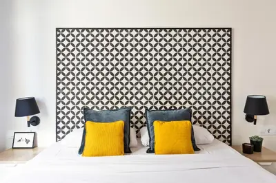 a bedroom with a large bed with yellow pillows at Modern Catalan Apartments by Olala Homes in Hospitalet de Llobregat