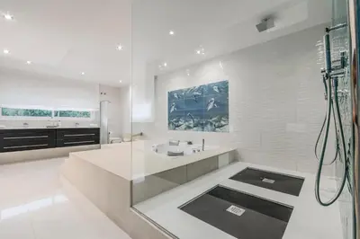 a white bathroom with a shower and a sink at Luxurious Villa Marly I to two minutes the beach in Castelldefels