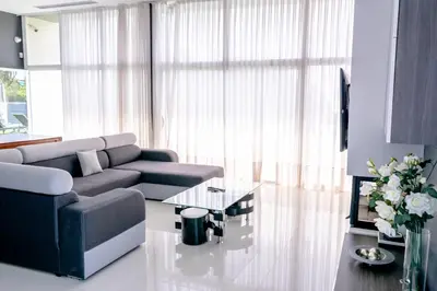 a living room with a couch and a glass table at Luxurious Villa Marly I to two minutes the beach in Castelldefels