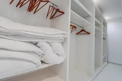 a closet filled with lots of white towels at Luxurious Villa Marly I to two minutes the beach in Castelldefels