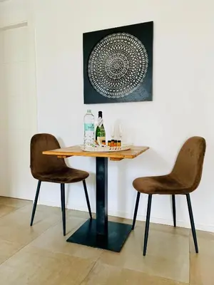 a table and two chairs in a room at Destino Sitges in Sitges