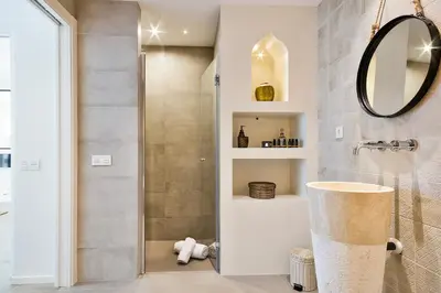 a bathroom with a shower and a mirror at Destino Sitges in Sitges