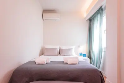 a bedroom with a bed with two pink towels on it at Sweett - Atic Eloi in Barcelona