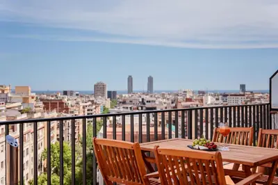 a wooden table with a bowl of fruit on a balcony at Sweett - Atic Eloi in Barcelona
