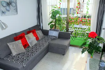 a couch with pillows on it in a living room at Cosmo Grey in Hospitalet de Llobregat