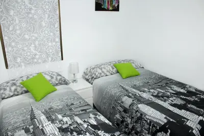 two beds sitting next to each other in a bedroom at Cosmo Grey in Hospitalet de Llobregat