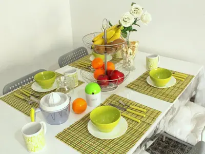 a table with plates and bowls of fruit on it at Cosmo Grey in Hospitalet de Llobregat