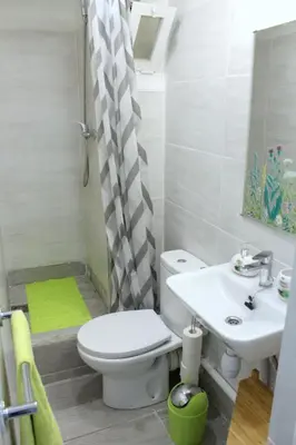 a bathroom with a toilet and a sink at Cosmo Grey in Hospitalet de Llobregat