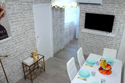 a dining room with a white table and white chairs at Cosmo Grey in Hospitalet de Llobregat