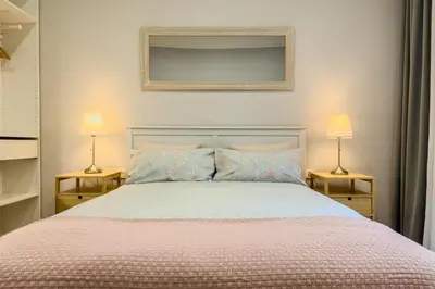 a bedroom with a large bed with two lamps at Novus Homes Barcelona Eixample in Barcelona